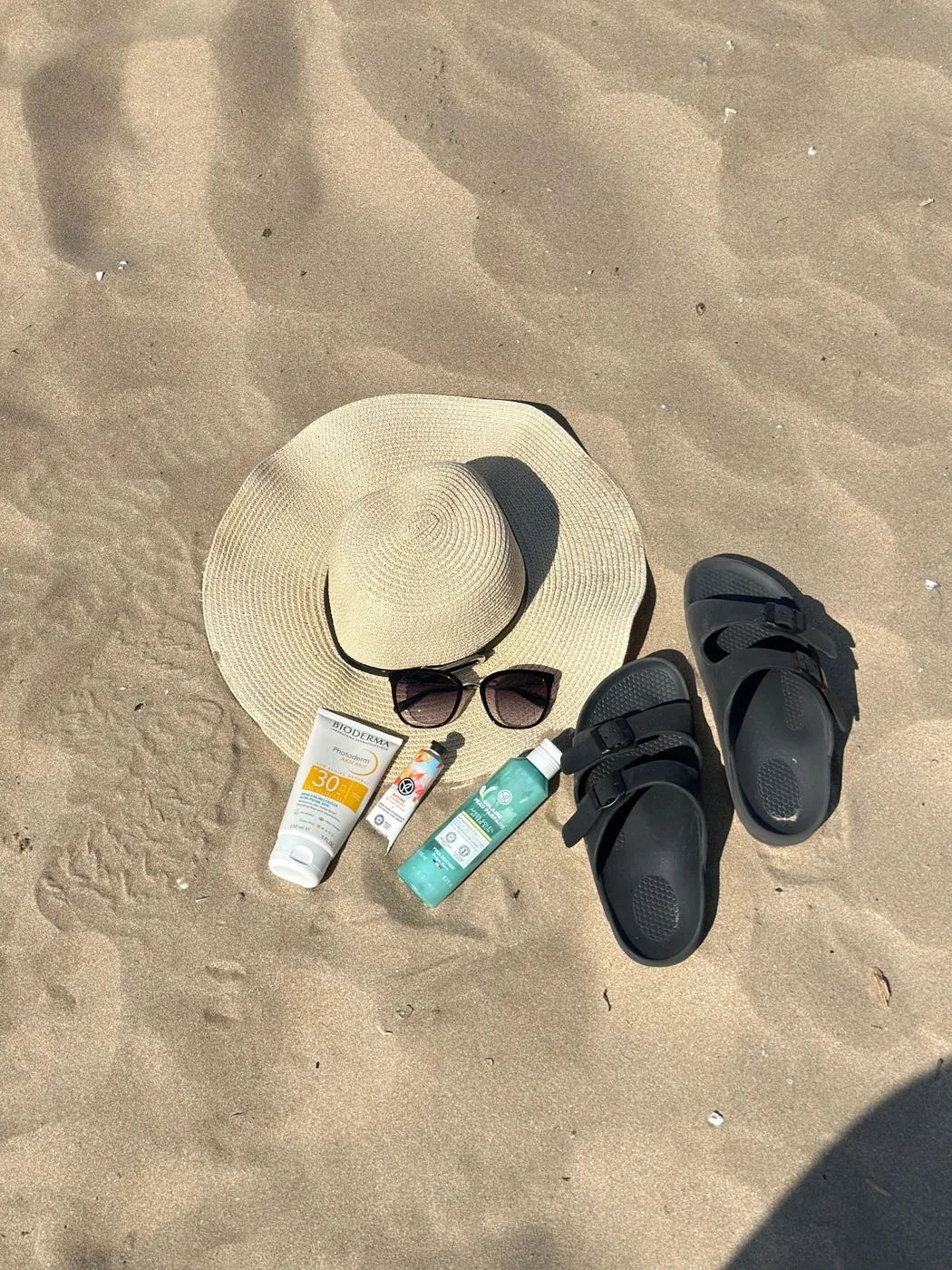 Chapeau et accessoires de plage sur le sable